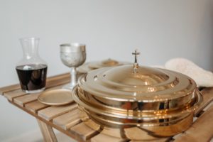 communion tray and wine on a decanter