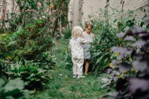 calm stylish children spending time together in garden